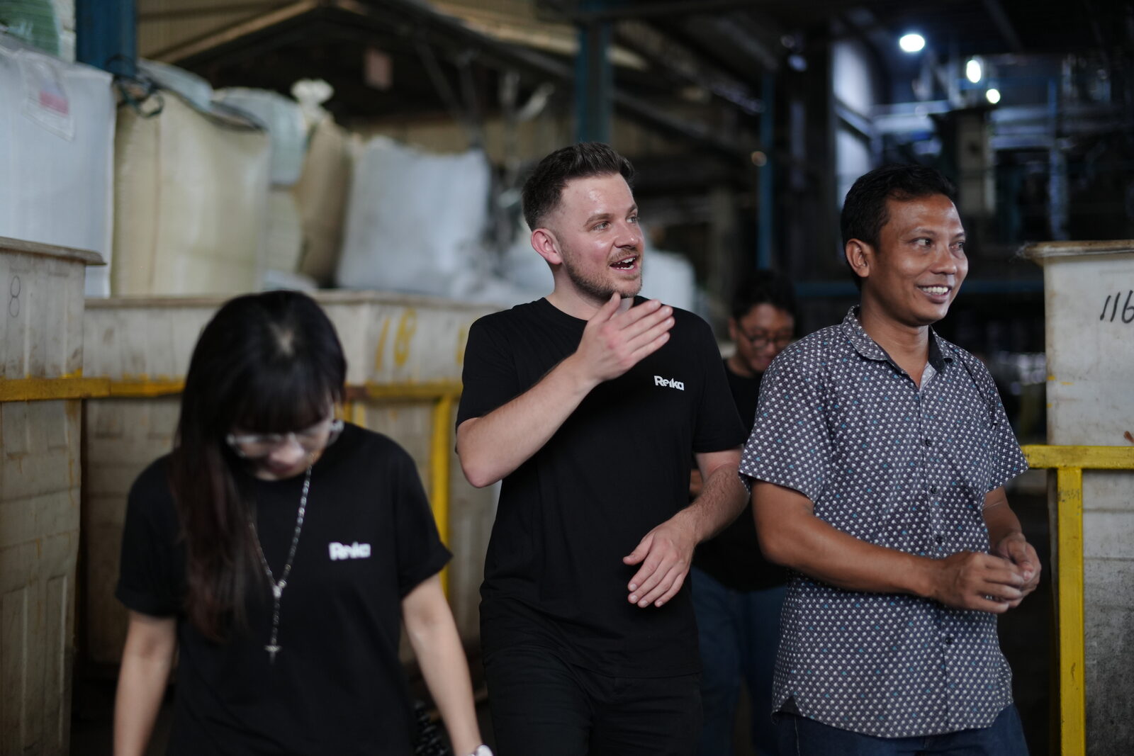 Sam with factory team reviewing production standards