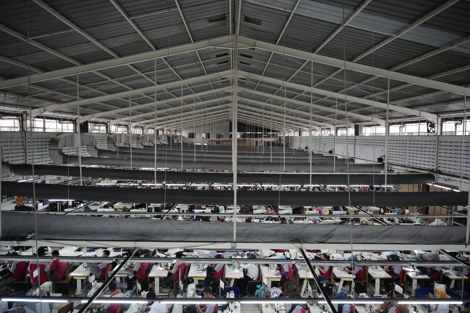 Wide factory floor with production lines running