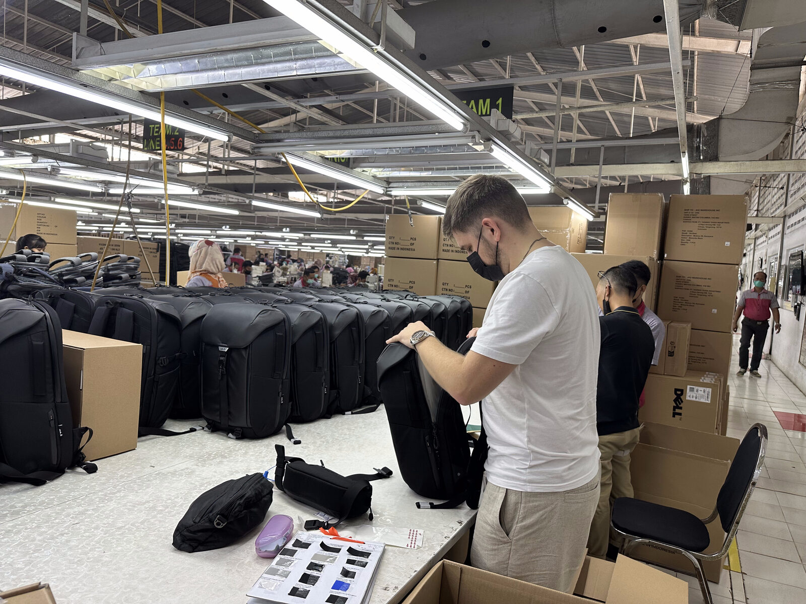 Product review and tech pack materials on design desk