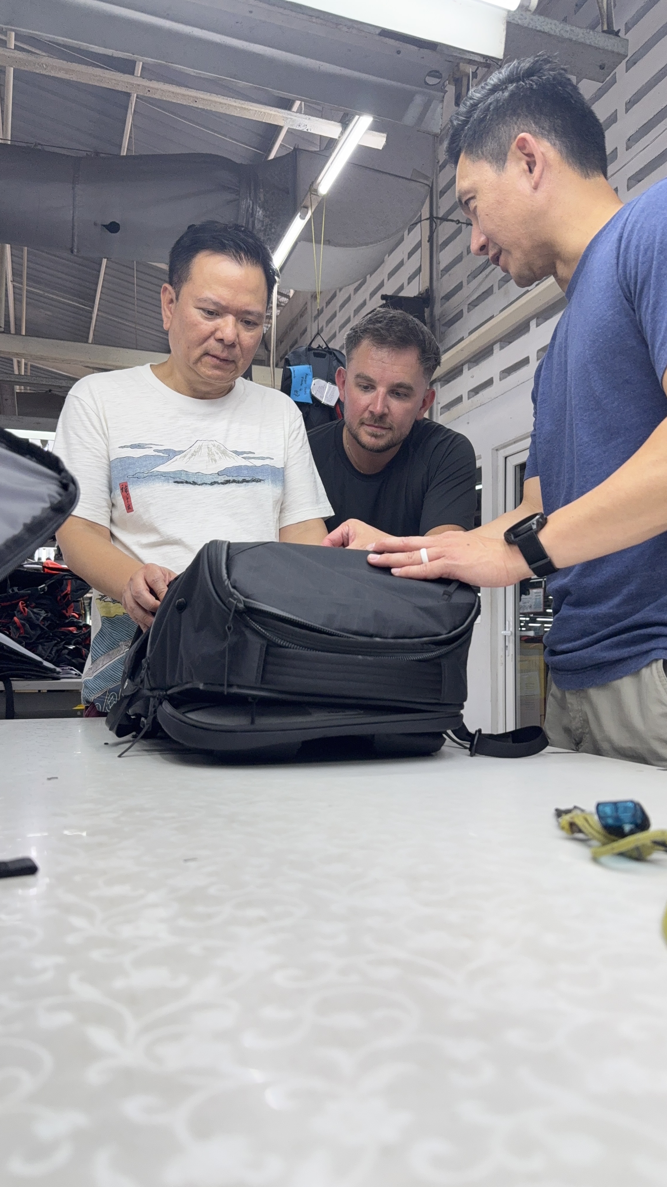 Sam and factory team reviewing golden sample on the production floor