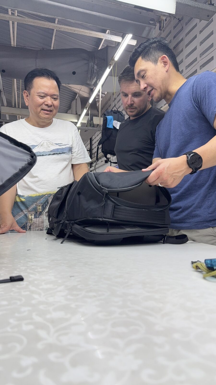 Sam reviewing DVRGE backpack with factory team