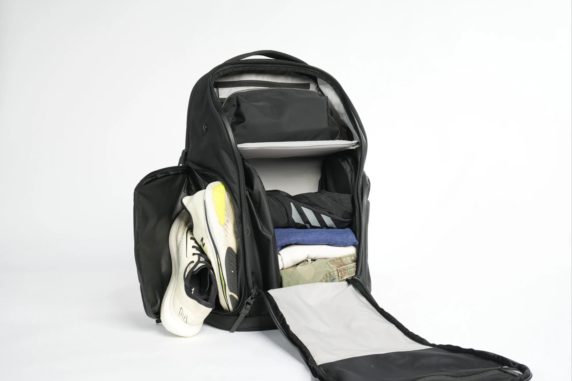 Interior layout showing shoe compartment, clothing, and laptop organisation