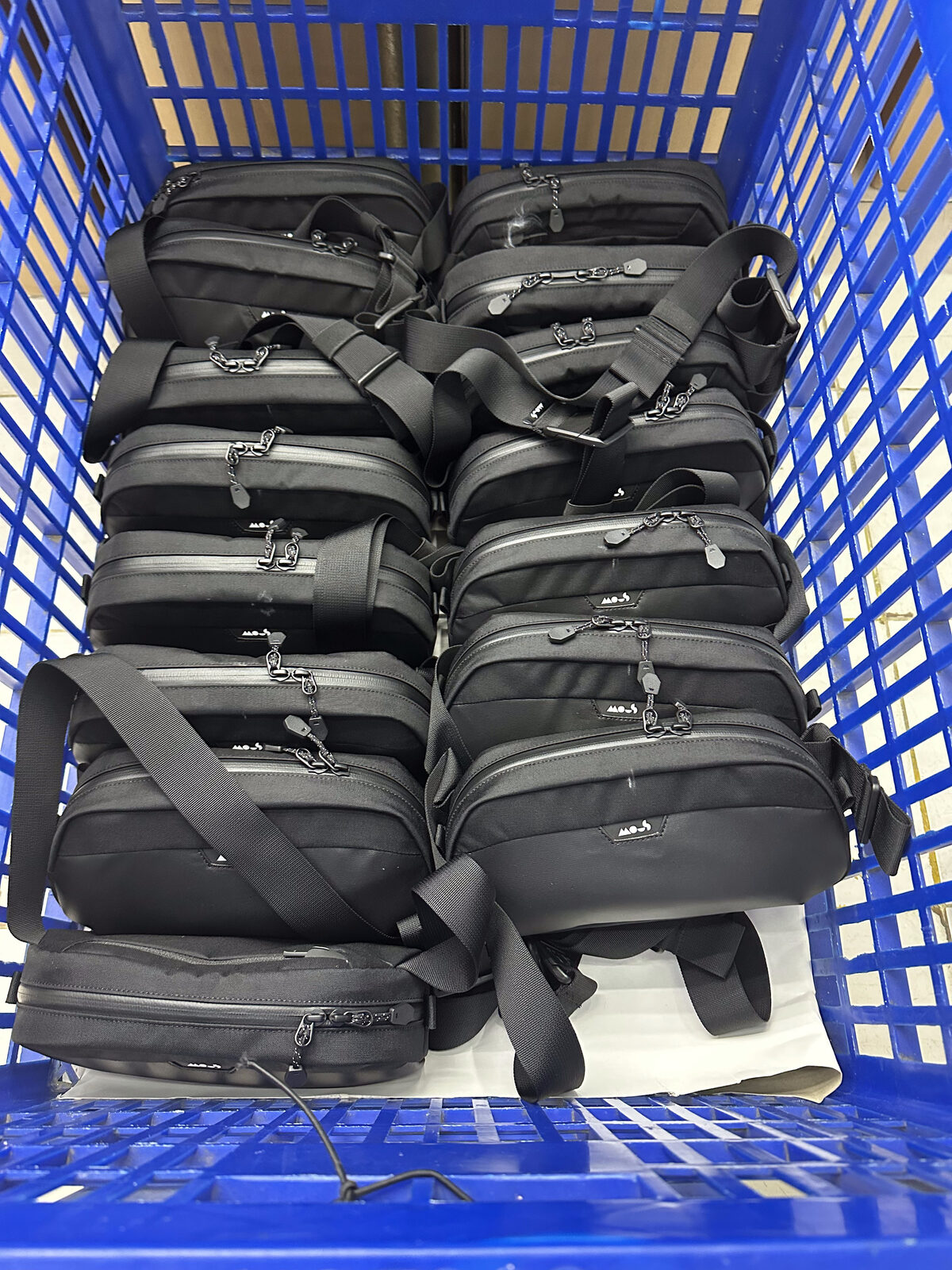 Mous Tech Pouches in factory bins ready for QC