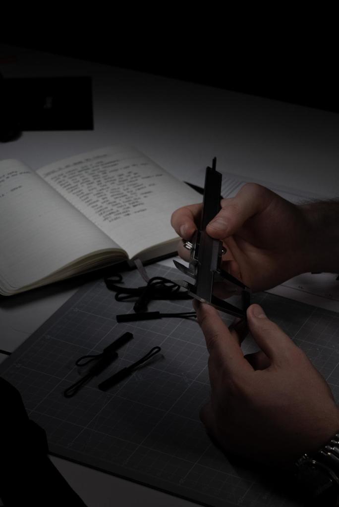 Caliper measurement of custom zipper pulls with development notebook