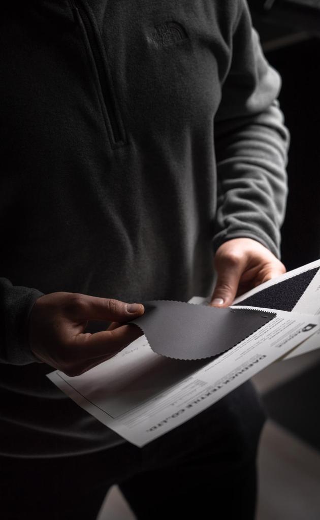 Reviewing DI-TEX fabric swatches against specification sheet